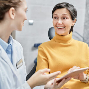 Periodontal Dental Implant patient talking to her Surgeon
