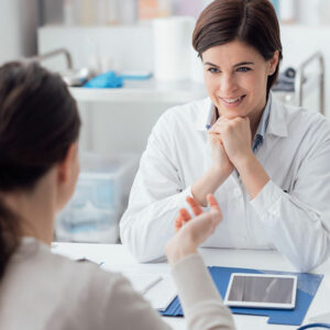 A periodontist consults with a patient