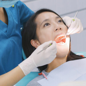 A periodontal patient receives an oral cancer exam